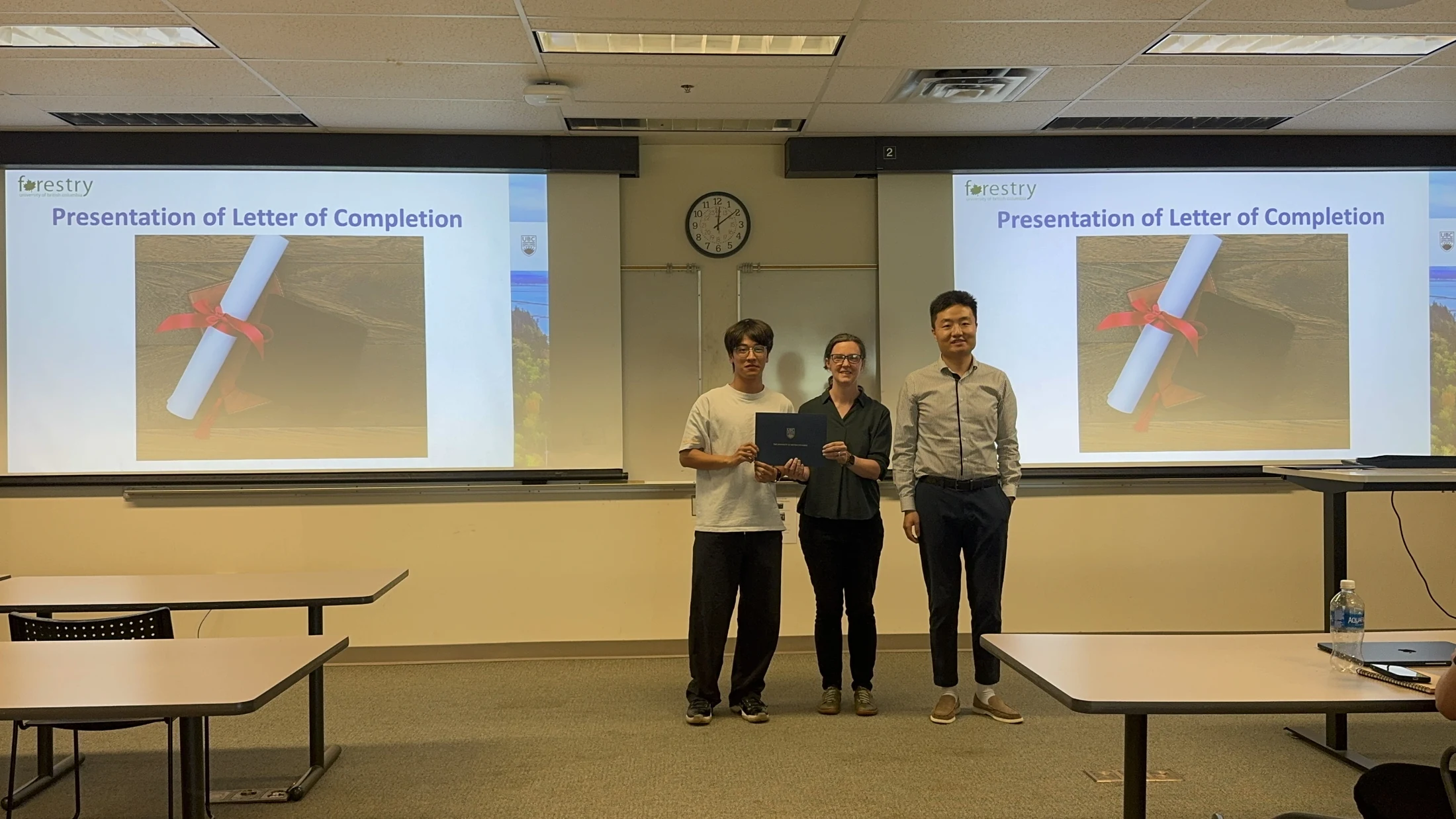 A student receiving a UBC Forestry Summer Institute letter of completion